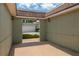 Open-air patio with brick flooring and a view leading to the parking area and garage at 2219 Starboard Rd, Winter Haven, FL 33881
