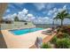 Community swimming pool with lounge chairs and lake views, perfect for relaxation at 2219 Starboard Rd, Winter Haven, FL 33881
