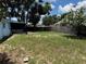 Fenced backyard, ideal for outdoor activities, features mature trees at 225 W Orange St, Lake Alfred, FL 33850