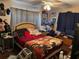 Bedroom with ceiling fan, covered in personal items at 225 W Orange St, Lake Alfred, FL 33850