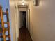 Hallway with neutral walls and hardwood floors connecting rooms at 225 W Orange St, Lake Alfred, FL 33850