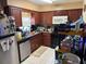 Galley kitchen with wood cabinets and stainless steel appliances at 225 W Orange St, Lake Alfred, FL 33850