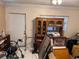 Utility room with door to the outside, moving boxes, and oak cabinet at 225 W Orange St, Lake Alfred, FL 33850