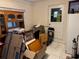 Utility room with door to the outside, moving boxes, and oak cabinet at 225 W Orange St, Lake Alfred, FL 33850