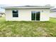 Backyard view showcasing the home's exterior with a sliding glass door at 2521 Sunset Dr, Winter Haven, FL 33881
