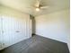 Cozy bedroom with carpet, ceiling fan, and double door closet for ample storage at 2521 Sunset Dr, Winter Haven, FL 33881