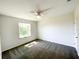 Neutral bedroom with window for natural light and a ceiling fan at 2521 Sunset Dr, Winter Haven, FL 33881