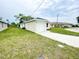 Exterior side view of a well-maintained home with lush green lawn and a one-car garage at 2521 Sunset Dr, Winter Haven, FL 33881