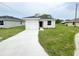 Charming single-story home featuring a one-car garage, fresh landscaping, and a green lawn at 2521 Sunset Dr, Winter Haven, FL 33881