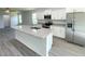 Bright kitchen features stainless steel appliances, white cabinets, granite countertops, and a large center island at 2521 Sunset Dr, Winter Haven, FL 33881
