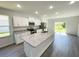 Modern kitchen features a spacious center island with granite countertops and white cabinetry at 2521 Sunset Dr, Winter Haven, FL 33881