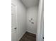 Well-lit laundry room with wood-look flooring and utility connections at 2521 Sunset Dr, Winter Haven, FL 33881