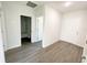 Open-concept living space with wood-look flooring and neutral paint throughout at 2521 Sunset Dr, Winter Haven, FL 33881