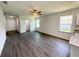 Spacious living area with wood-look floors, ceiling fan, and abundant natural light at 2521 Sunset Dr, Winter Haven, FL 33881