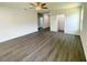 Large living room featuring wood-look floors, ceiling fan, and access to multiple rooms at 2521 Sunset Dr, Winter Haven, FL 33881