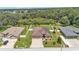 Aerial view of a home with a well-maintained lawn, fenced backyard, and mature trees at 2932 Blackwater Oaks Dr, Mulberry, FL 33860