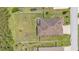 Top-down aerial view of a home with a fenced yard, screened enclosure, and fire pit at 2932 Blackwater Oaks Dr, Mulberry, FL 33860