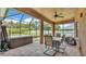 Relaxing screened porch area complete with a hot tub and dining table at 2932 Blackwater Oaks Dr, Mulberry, FL 33860