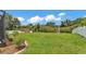Expansive backyard featuring lush green lawn, white fence, and a charming storage shed at 2932 Blackwater Oaks Dr, Mulberry, FL 33860