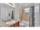 The bathroom features a shower-tub combo, vanity, and tiled accents, combining functionality with a clean design at 2932 Blackwater Oaks Dr, Mulberry, FL 33860