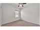 Neutral toned bedroom featuring carpet flooring, ceiling fan, and a bright window at 2932 Blackwater Oaks Dr, Mulberry, FL 33860