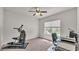 Neutral bedroom offers a ceiling fan, window and exercise equipment at 2932 Blackwater Oaks Dr, Mulberry, FL 33860