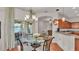 Dining area with hardwood floors, neutral paint, chandelier and sliding glass door to patio at 2932 Blackwater Oaks Dr, Mulberry, FL 33860