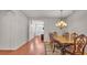 Formal dining room boasts beautiful wood table, chairs, hardwood floors and chandelier lighting at 2932 Blackwater Oaks Dr, Mulberry, FL 33860