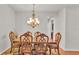 Formal dining room boasts beautiful wood table, chairs and chandelier lighting at 2932 Blackwater Oaks Dr, Mulberry, FL 33860