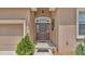 Close-up of the home's entryway with decorative sidelights and a stone walkway at 2932 Blackwater Oaks Dr, Mulberry, FL 33860