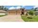 Charming single-story home featuring a well-manicured lawn and a spacious two-car garage at 2932 Blackwater Oaks Dr, Mulberry, FL 33860