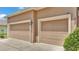 Attached two-car garage with paneled doors and exterior lighting at 2932 Blackwater Oaks Dr, Mulberry, FL 33860