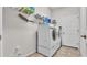 Bright laundry room featuring modern washer and dryer, plus shelving for storage at 2932 Blackwater Oaks Dr, Mulberry, FL 33860