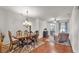 Open living room with hardwood floors, ceiling fan, dining set and cozy furniture at 2932 Blackwater Oaks Dr, Mulberry, FL 33860
