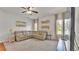 Cozy living room featuring a beige sectional sofa, natural light, and neutral wall decor at 2932 Blackwater Oaks Dr, Mulberry, FL 33860