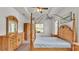 Spacious main bedroom features a decorative ceiling fan and matching wooden furniture set with a four-poster bed at 2932 Blackwater Oaks Dr, Mulberry, FL 33860