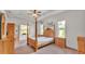 Bedroom featuring a decorative bed frame, natural light, and neutral wall decor at 2932 Blackwater Oaks Dr, Mulberry, FL 33860