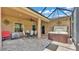 Covered patio with brick pavers, an outdoor dining set and a relaxing jacuzzi hot tub at 2932 Blackwater Oaks Dr, Mulberry, FL 33860