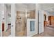The tiled shower features sliding glass doors, providing a spa-like experience in the main bathroom at 2932 Blackwater Oaks Dr, Mulberry, FL 33860