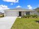 Charming single-story home with a well-maintained lawn and a two-car garage at 3167 Laurel Oak Ln, Winter Haven, FL 33884