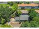 Aerial view of home showing the property, roof, driveway, and surrounding trees at 3542 Raintree Ct, Lakeland, FL 33803
