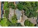Birds eye view of the property with green trees surrounding the house and other houses on the sides at 3542 Raintree Ct, Lakeland, FL 33803