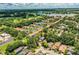 Aerial view showcases the property's setting near a golf course and lake, complete with community amenities and ample green space at 3542 Raintree Ct, Lakeland, FL 33803