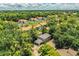An aerial view shows the property's location within a lush, green neighborhood with mature trees and nearby community buildings at 3542 Raintree Ct, Lakeland, FL 33803
