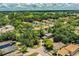 An aerial view showing the property nestled within a community of townhouses, mature trees, and proximity to a golf course at 3542 Raintree Ct, Lakeland, FL 33803