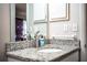 Bathroom featuring a granite countertop, modern faucet, and a neutral color scheme at 3542 Raintree Ct, Lakeland, FL 33803