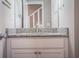 Bathroom vanity featuring a speckled countertop and white cabinets with a sink and brushed nickel faucet at 3542 Raintree Ct, Lakeland, FL 33803