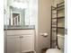 Bathroom with a white vanity and a countertop, accompanied by a decorative black metal shelf unit at 3542 Raintree Ct, Lakeland, FL 33803