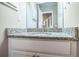 Bathroom vanity featuring a speckled countertop and white cabinets with a sink and brushed nickel faucet at 3542 Raintree Ct, Lakeland, FL 33803