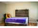Cozy bedroom featuring a rustic wood bed frame, a chair, and neutral wall paint at 3542 Raintree Ct, Lakeland, FL 33803